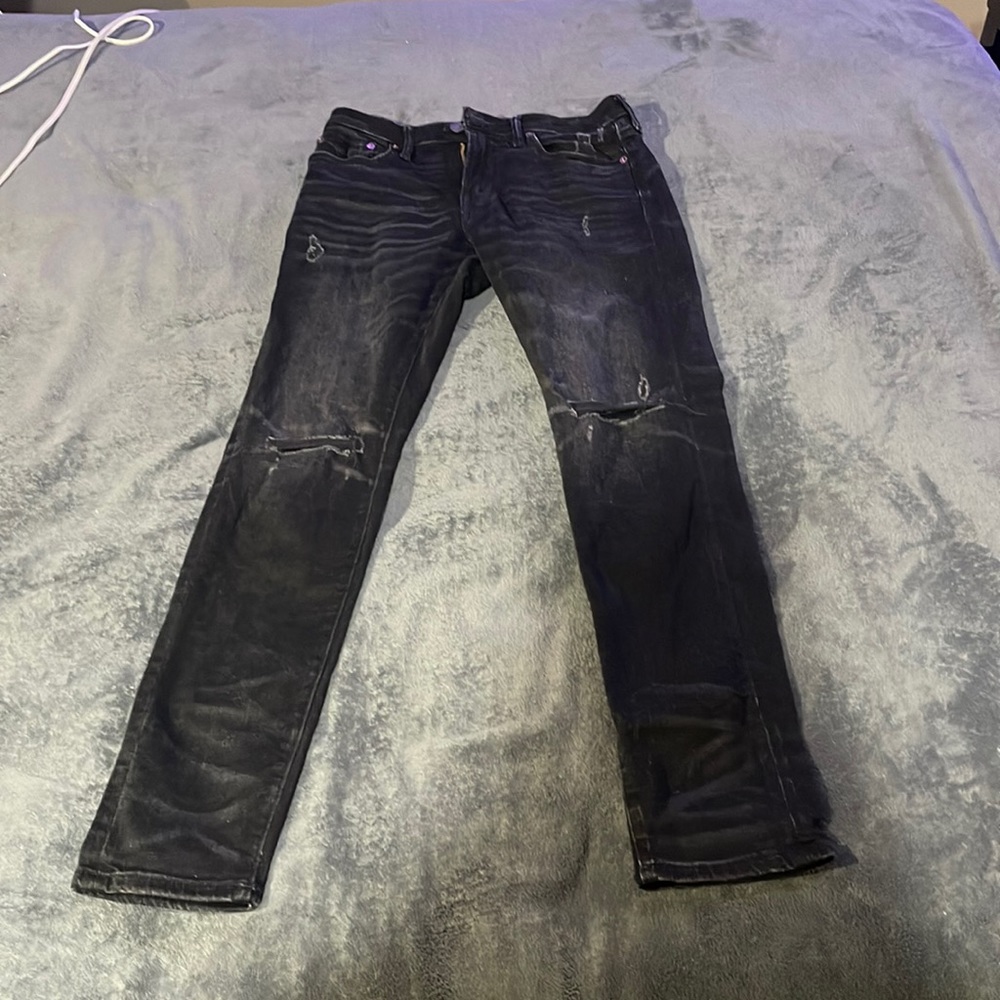 Black American eagle jeans with rips in them